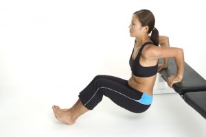 Female doing bench dips for bingo wings